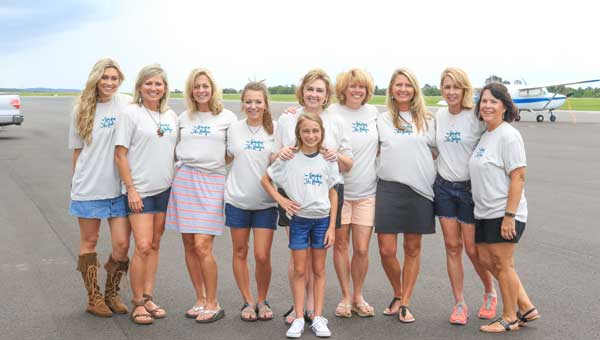 Marleigh Ingle, center, her sister Bailey, far left, and their mother, Teresa, next to Bailey, gather with members of the Hoover Kappa Delta Alumnae Chapter.