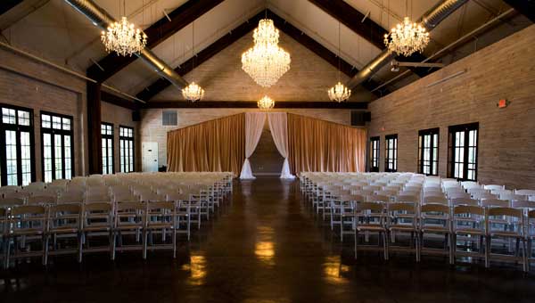 There are large chandeliers that add to the elegant, rustic design in The Carriage House.